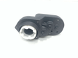 The black mechanical device with a white circular component resembles the Right Gear Box from Enhance Your 12V Discovery with the Perfect Gear Box: Find the Right Fit Today! Featuring screws and raised elements, its set against a plain white background.