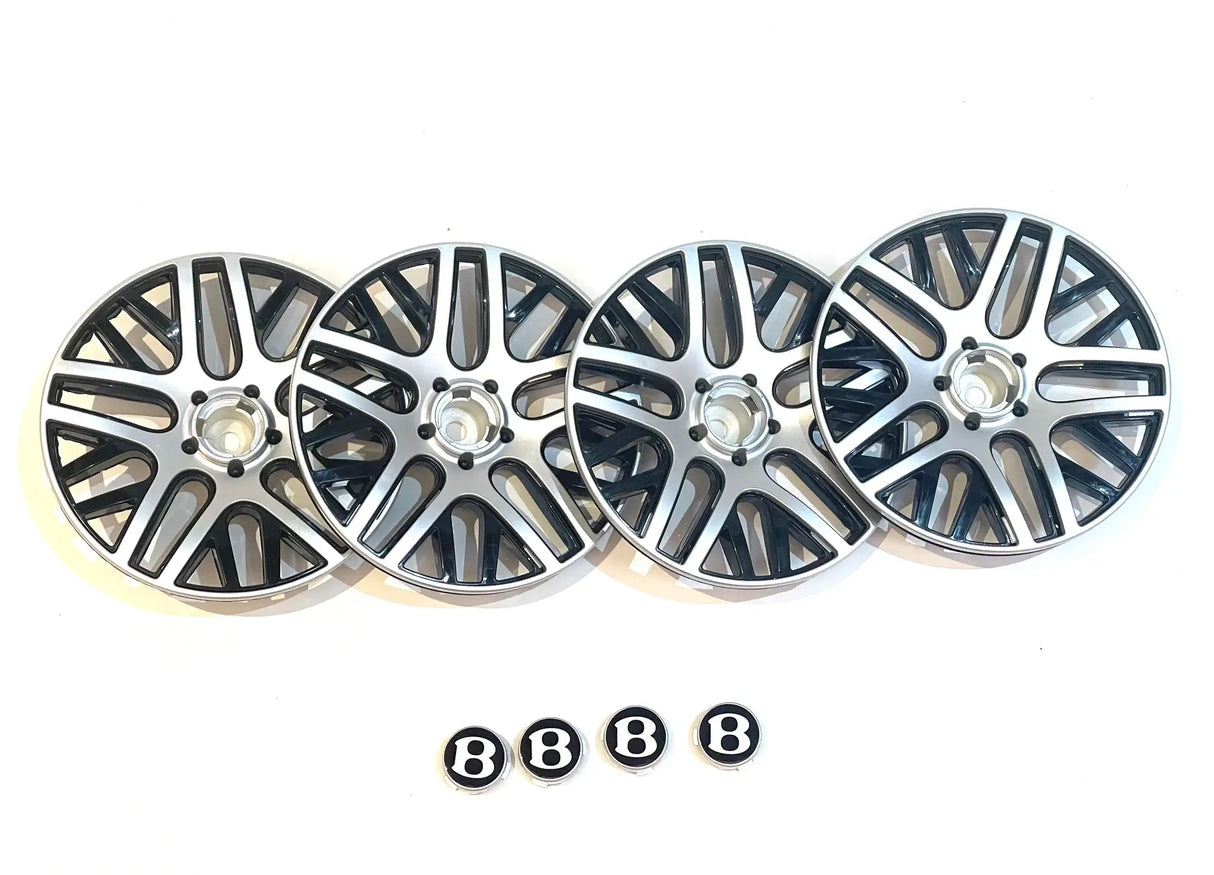 Four 12V Bentley Sport GT rims in silver and black are arranged on a white surface, with five hubcap center badges featuring a B logo below. Perfect for automotive enthusiasts or Kids VIP Online shoppers seeking exclusive ride-on car accessories at Final Sale.