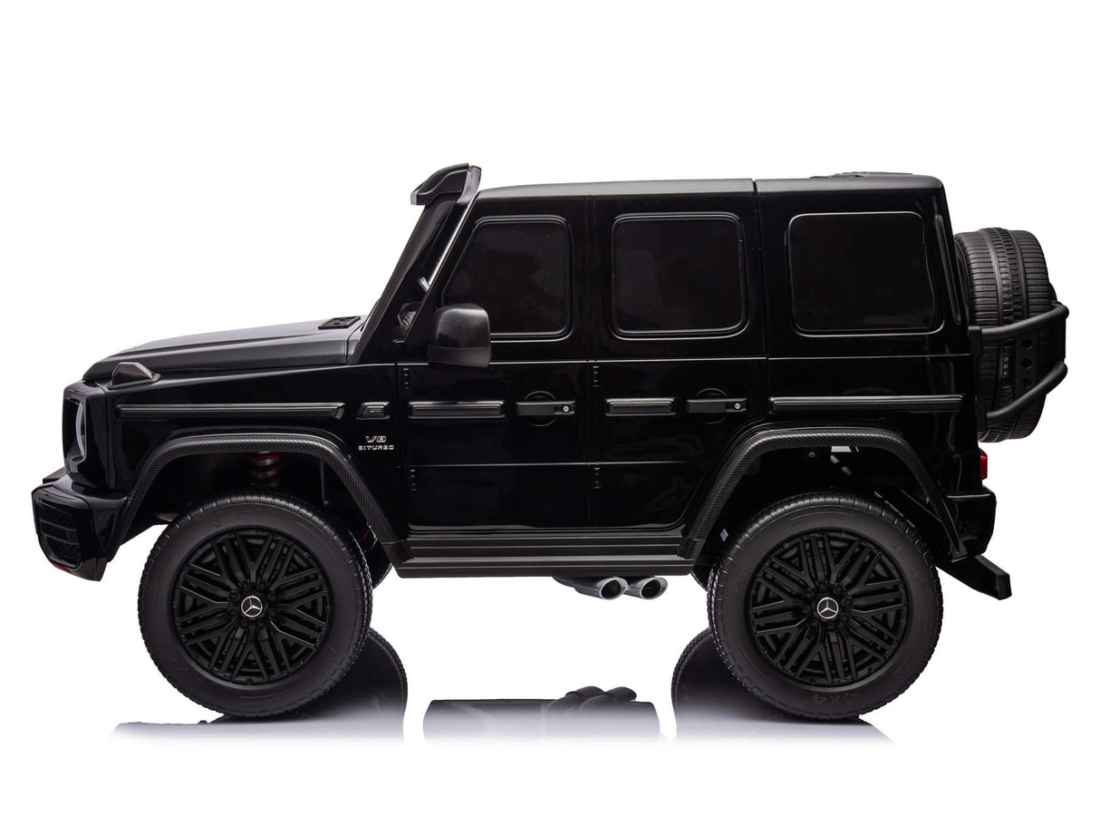 The Black Mercedes G63 XXL 24V Kids Ride-On Truck – Platinum Edition is shown from the side on a white backdrop, highlighting its EVA tires, spare tire, and detailed features like doors, windows, and mirrors.