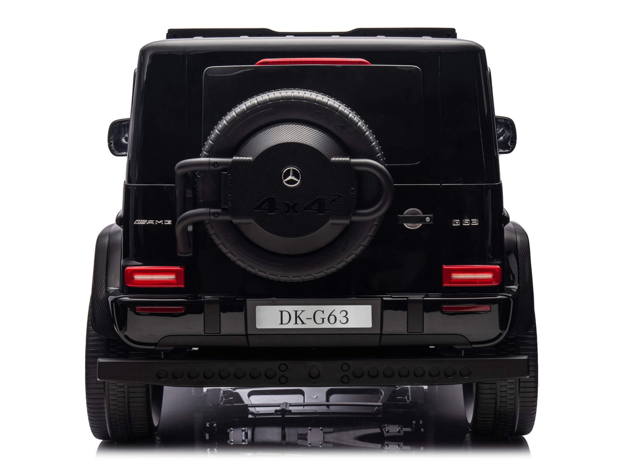 The image displays the rear of a black Mercedes-Benz G-Class SUV, similar to the XXL Mercedes G63 Kids Ride-On featuring a spare tire labeled 4x4², a license plate DK-G63, distinctive tail lights, resembling the Black Mercedes G63 XXL 24V Kids Ride-On Truck – Platinum Edition with MP4 and more.