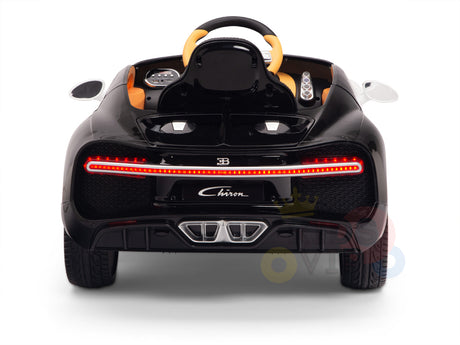 The White 12V Bugatti Chiron Kids Ride On Car offers rubber wheels, red tail lights, and detailed engine vents. With a steering wheel and the Chiron label, this licensed 1-seater embodies luxury in toy form.