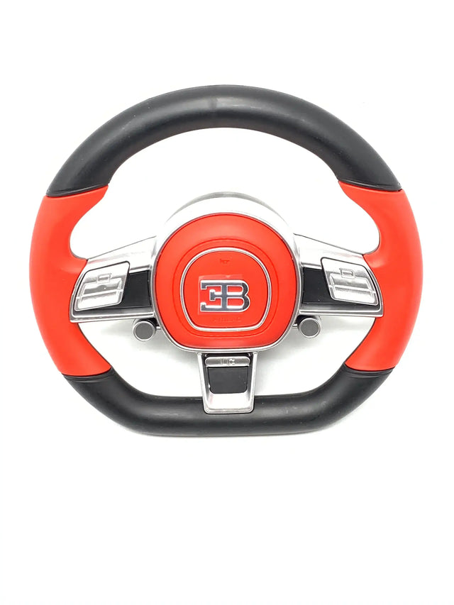 A stylish black and red steering wheel with chrome EB emblem for the 12V Bugatti Divo ride-on car, featuring buttons and a smooth circular handle.