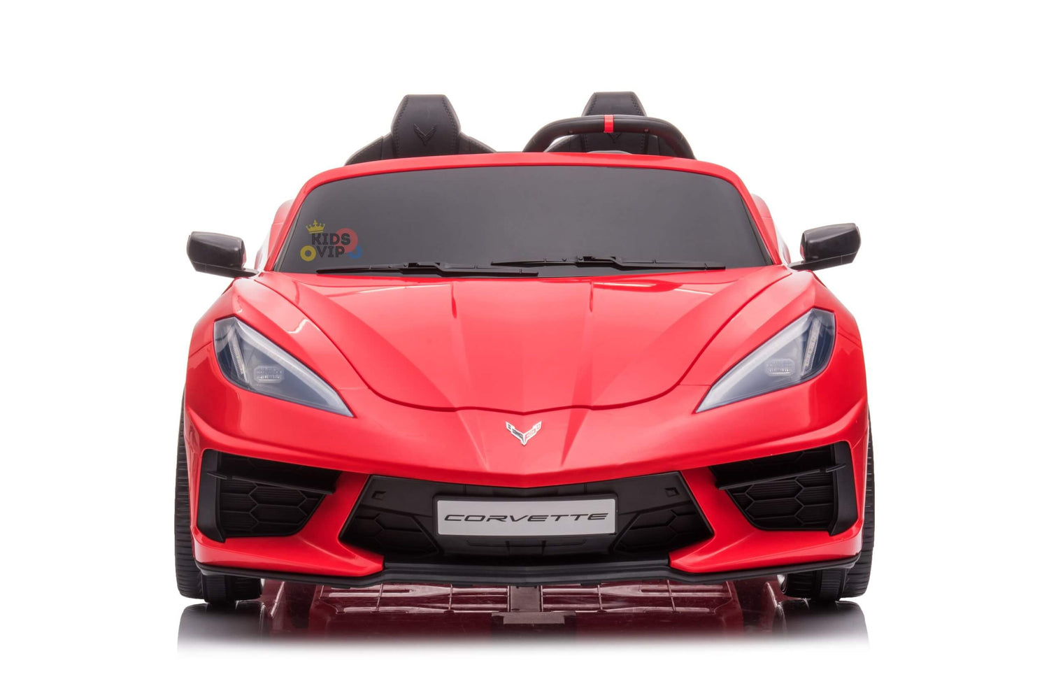 A front-view of the red Corvette C8 toy car, featuring sleek lines, angular headlights, a black windshield, and Corvette on the bumper. This Kids Premium 24V model has two small seats in its dual-seater design with EVA wheels and leather seats, remote control included.