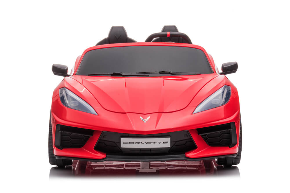 A Kids Premium 24V Red Corvette C8 Dual-Seater ride-on toy car, with EVA wheels and leather seats, looks like a sporty convertible. It features sleek headlights, side mirrors, and the Corvette logo on the front bumper against a white background.
