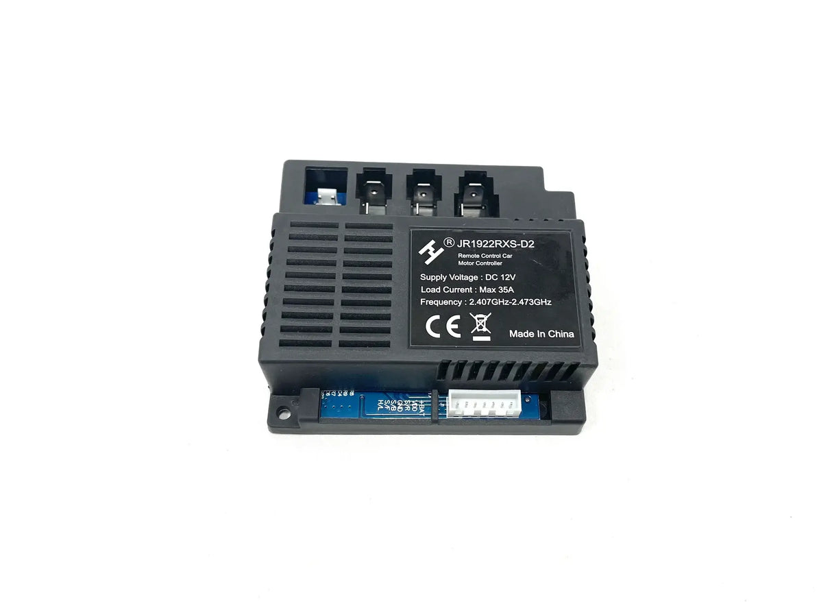 The 12V Unimog Receiver is a black electronic module with a textured surface and three top terminals, displaying voltage and frequency specifications. It is labeled Made in China and has a blue component underneath. This final sale item is available for inquiries.