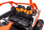 A close-up of the Orange 2x24V/2WD Can-Am Maverick Ride on Buggy, LX Performance features a sporty, rugged design with dual seats sporting orange headrests and black cushions. The visible steering wheel and dashboard enhance its adventurous appeal.