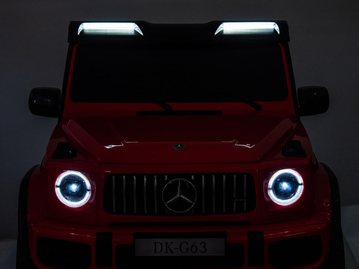 The Red 2x24V/4WD Platinum XXL Mercedes G63 Ride On Truck resembles a luxury SUV with illuminated headlights, roof lights, remote control access, a silver grille emblem, and the DK-G63 license plate for ultimate performance.