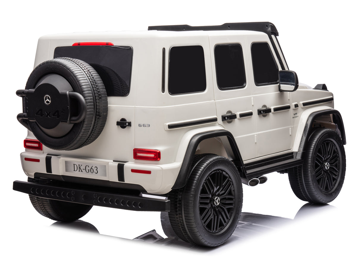 A toy model of the white 2x24V/4WD Platinum XXL Mercedes G63 Ride-On Truck, featuring a black spare tire cover, black wheels, and a 4x4 emblem on the back. It includes tinted windows and realistic detailing on a reflective surface but lacks remote control access.