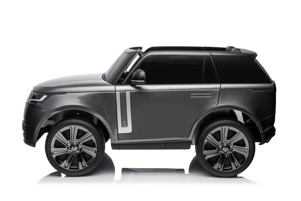 The Grey 24V Kids Range Rover Ride-On SUV, displayed in profile against a white background, boasts luxury details like detailed wheels, tinted windows, and silver side accents. Designed for aspiring young drivers, it offers premium features and parental control.