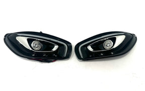 The 12V Mercedes GTR Set Of Headlights features sleek, angular designs with chrome accents and circular LED lights on a white background. Perfect for enhancing your ride-on car experience, these premium accessories are now available at final sale exclusively at kidsviponline.