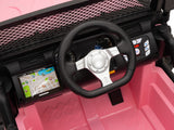 The Pink 24V EVA Big Wheels Ride-On Truck features a close-up of its interior, showcasing a black steering wheel, map screen, control panel with buttons, diamond-patterned floor design—all powered by a robust 24V battery for thrilling kids adventures.