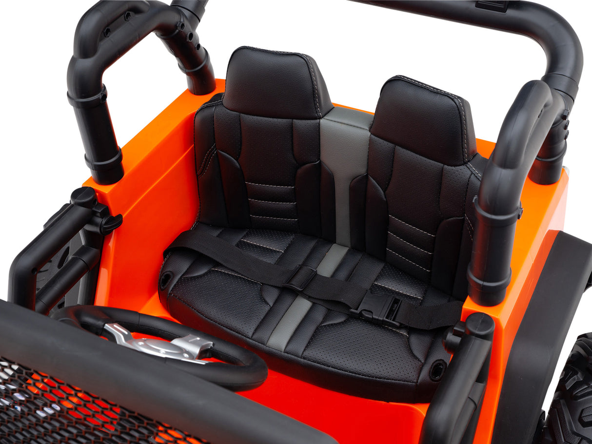 A close-up of the Orange 24V EVA Big Wheels Kids 1 Seater Upgraded Ride On Trucks interior shows a black seat with a safety harness, perfect for kids. The dashboard and steering wheel exhibit a realistic design, enhanced by its remote control functionality.