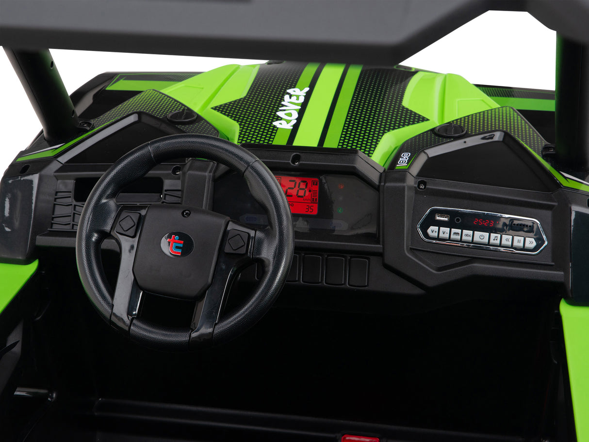 Close-up of the Green 2 Seats Golf Buggy 24V Edition dashboard in black and green. It features a steering wheel with a red emblem, digital display with numbers, various console buttons and controls, and durable EVA rubber wheels for smooth rides.