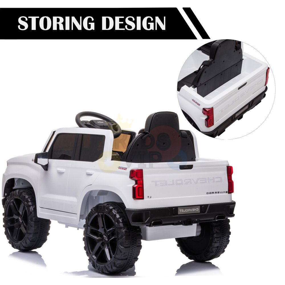 The White 12V Chevrolet Silverado Kids Licensed Ride On Truck features a clever storage compartment under the seat, emphasized by a circular inset highlighting its STORING DESIGN. With large black wheels and remote control, it offers upgraded features for adventurous play.