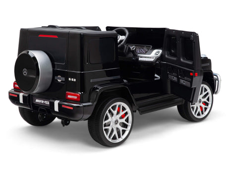 The Black 24V/4x4 Official Mercedes Benz G63 Ride On Car with RC features realistic detailing, including a spare tire, silver rims, and a visible steering wheel and dashboard.