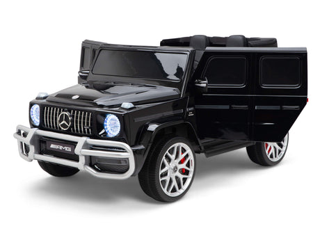 The Black 24V/4x4 Official Mercedes Benz G63 Ride On Car with RC is a toy replica for kids featuring AMG branding, detailed silver rims, emblem, and bumper. Illuminated by a 24V battery, the headlights enhance its realistic appearance.
