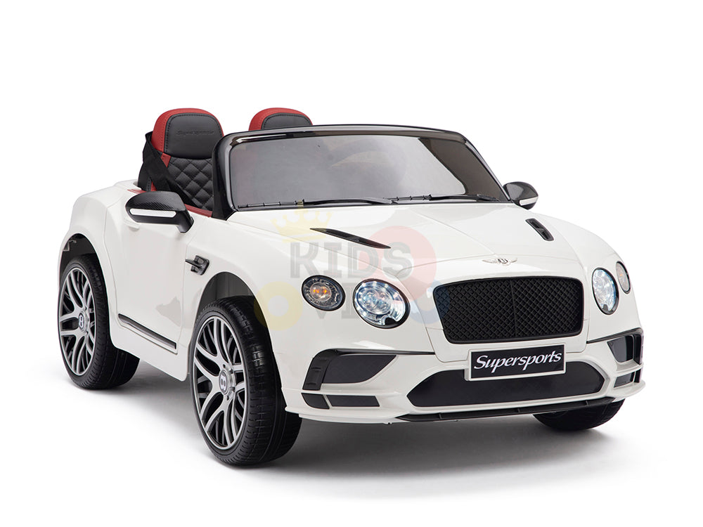 The White 12V Bentley GTC Kids Licensed Ride-On Car features rubber wheels, a remote, black trim, a luxurious red and black leather seat, a detailed front grille, and the Supersports label.