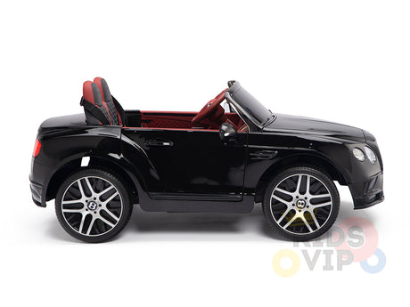 A sleek black 12V Bentley GTC Kids Licensed Ride On Car sits on a white background, featuring a red interior, rubber wheels with the brand logo, and realistic details including a detailed dashboard. Designed for adventurous children. Comes with remote control for added security.