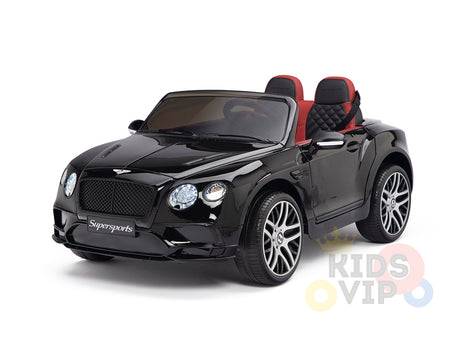 A black 12V Bentley GTC Kids Licensed Ride On Car with rubber wheels and remote, featuring front headlights, detailed grille, red-black seats, and Supersports on the front, is displayed on a white background. The partial KIDS VIP logo appears at the bottom right.