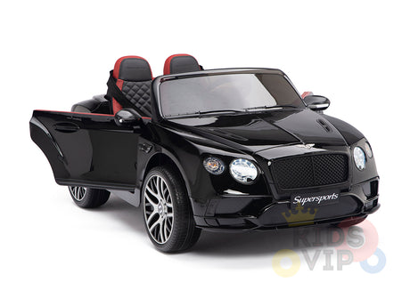 The Black 12V Bentley GTC Kids Licensed Ride-On Car features rubber wheels, a remote control, and stylish two-tone red and black seats. It resembles a Bentley Sport GT with open doors, a detailed grille, silver alloy wheels, and branding on the front for added safety and fun.