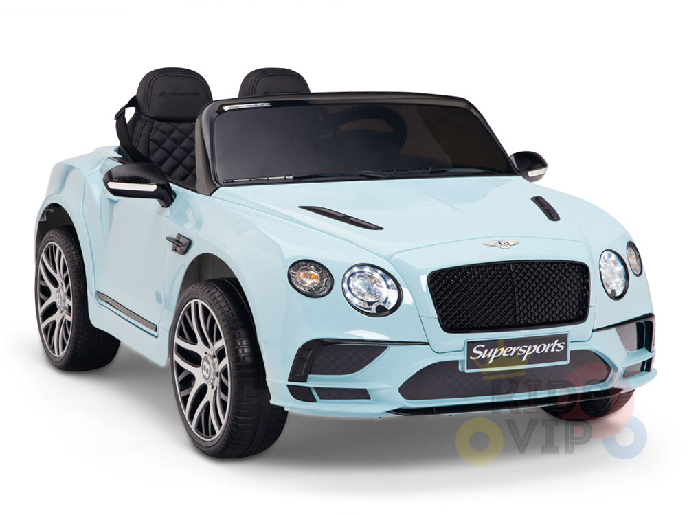 The Blue 12V Bentley GTC Kids Ride On Car features luxury details like a grille, headlights, rubber wheels, and sleek black leather seats. It includes a remote for easy navigation and is labeled Supersports on the front plate.