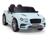 A pale blue Bentley GTC 12V Kids Licensed Ride On Car with rubber wheels and remote, designed to resemble a luxury sports model. It features black leather seats, detailed headlights, a Supersports label on the front, and is displayed on a white background.