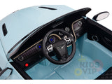A top view reveals the Blue 12V Bentley GTC Kids Licensed Ride On Cars interior, showcasing a detailed steering wheel, illuminated dashboard controls, start button, leather seat, and textured floor. Luxury details include the Kids VIP logo and rubber wheels.
