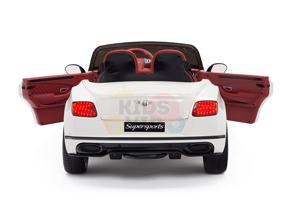 The White 12V Bentley GTC Kids Licensed Ride On Car features red leather seats, Supersports on the back, illuminated taillights, rubber wheels, and both doors open. Enjoy the thrill with this remote control convertible!.