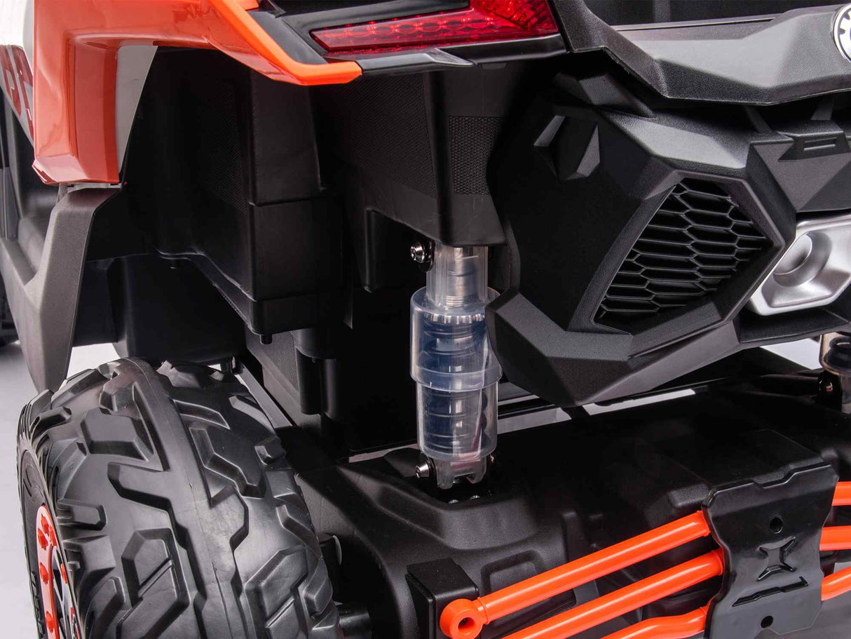 Close-up of the rear part of the Orange 2x24V/2WD Official Can-Am Maverick Ride on Buggy with large black and orange wheels, a transparent cylindrical component near the base, and red accents on the frame and rear lights.