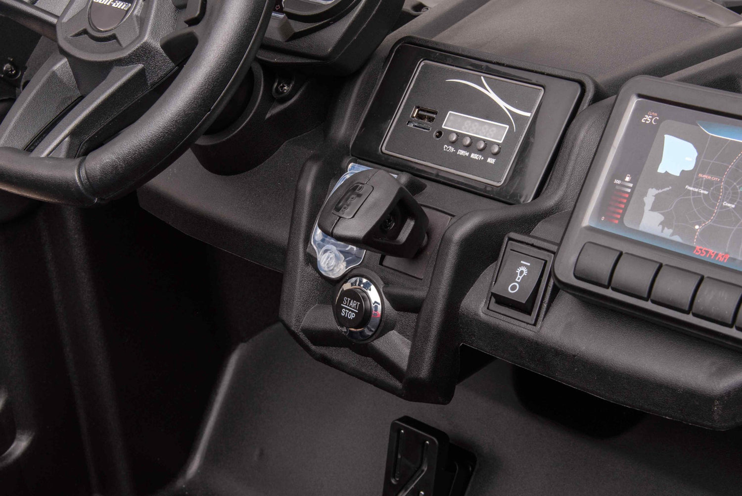 Close-up of a vehicle dashboard featuring a steering wheel, map displayed digitally, and the LX Performance start-stop button. Various controls and a USB port are set against the sleek black interior of the Pink 2x24V/4WD Official Can-Am Maverick Ride on Buggy, LX Performance.