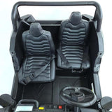 The interior of the White 24V/180W XXL Big Kids Blade XR Ride on Buggy features two black, cushioned seats with hexagonal patterns and seatbelts. It has a dashboard with a small steering wheel, buttons, and a display, while inflatable rubber tires ensure smooth rides ahead.