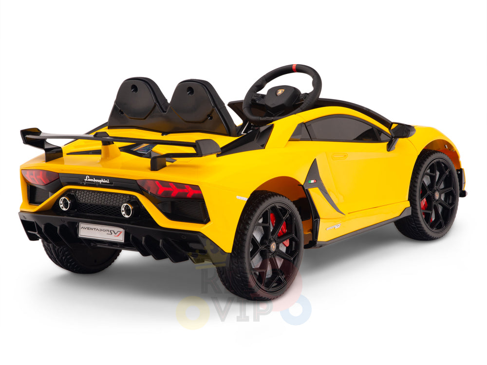 This Yellow 12V Lamborghini SVJ ride-on car for kids features a sleek design with black seats, a steering wheel, red-accented rims and brake calipers, realistic headlights, and a rear spoiler.