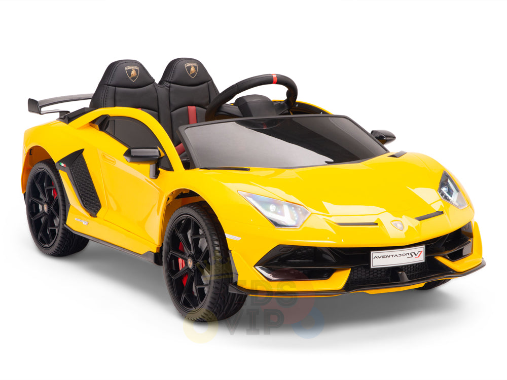 The Yellow 12V Lamborghini SVJ Sport Kids Licensed Ride-On features a realistic design with sleek lines, black seats, steering wheel, visible headlights, and black wheels with red accents. This 1-seater model boasts rubber wheels and comes with a remote.