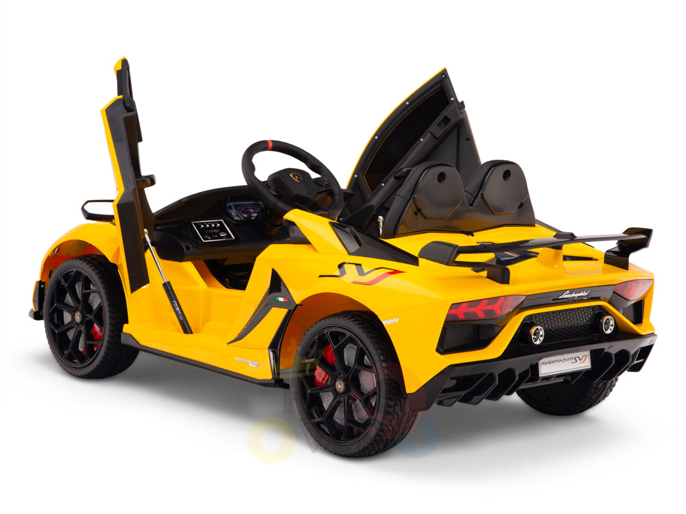 A yellow 12V Lamborghini SVJ Sport Kids Licensed Ride-On Car is featured, showcasing open scissor doors, black accents, red decals, a black interior with a steering wheel, and detailed rear lights. The toy car is angled to highlight one side and the back.