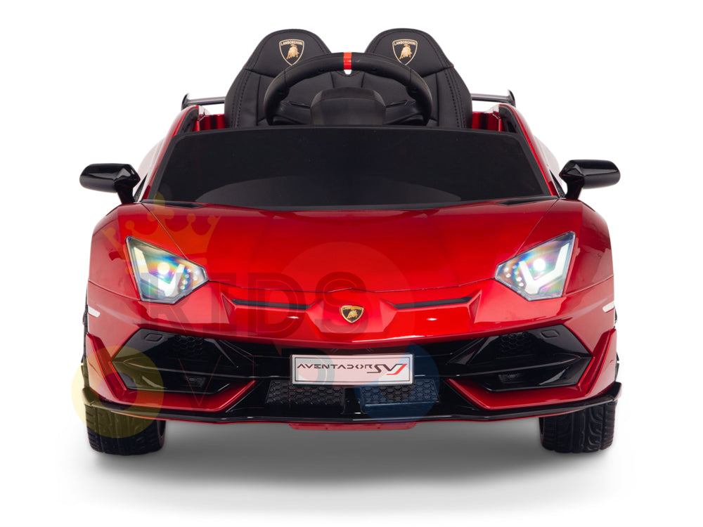 The Burgundy Red 12V Lamborghini SVJ Sport Kids Licensed 1 Seater Ride On Car features LED headlights, mirrors, racing seats, rubber wheels, a sleek body, and a remote for added safety.
