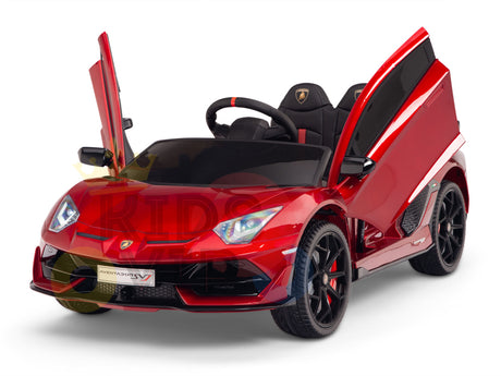The Burgundy Red 12V Lamborghini SVJ Sport Kids Licensed 1 Seater Ride On Car, featuring rubber wheels and a remote, showcases open scissor doors and sleek black seats on a white background. It comes with a steering wheel and sport-style rims for an exhilarating experience.