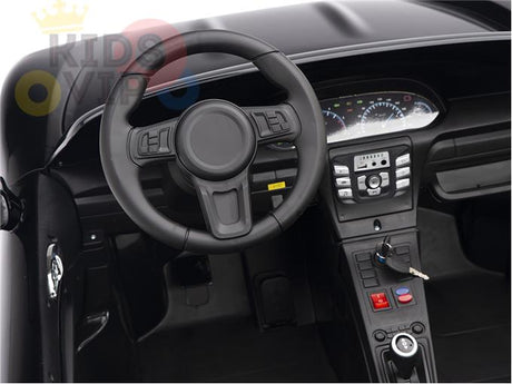The Black 24V XXL SuperSport Big Kids Ride On Car boasts a realistic interior with a steering wheel, dashboard, speedometer, and control panel complete with buttons and an ignition key. Its detailed craftsmanship includes ECO leather seats that emulate a real cars cockpit.