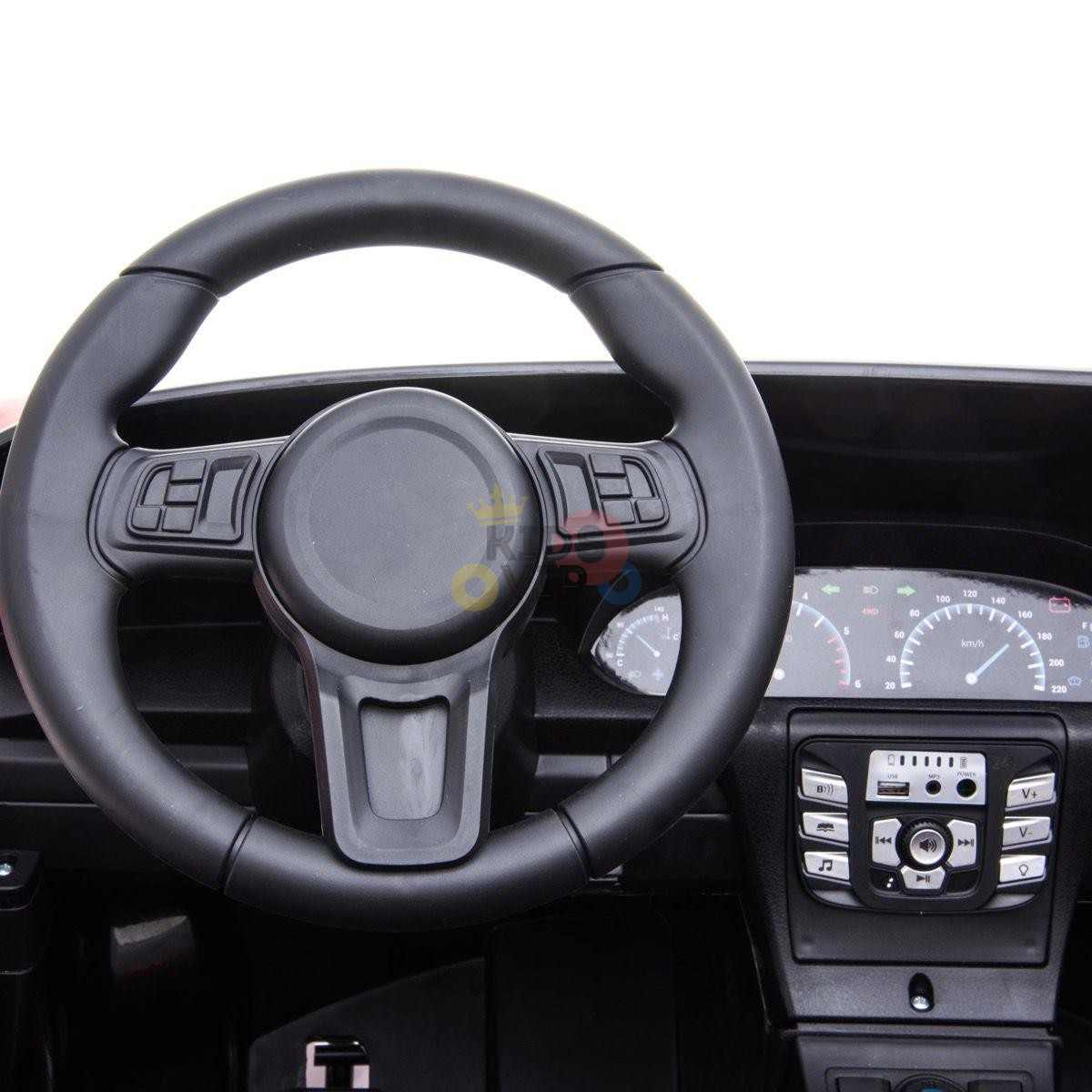 Close-up of a car dashboard showcasing a black steering wheel, central console with controls, and an instrument panel with gauges, reminiscent of the sleek interior found in the Orange 24V XXL SuperSport Big Kids Ride On Car, featuring real air-filled tires and a 180W brushless motor.