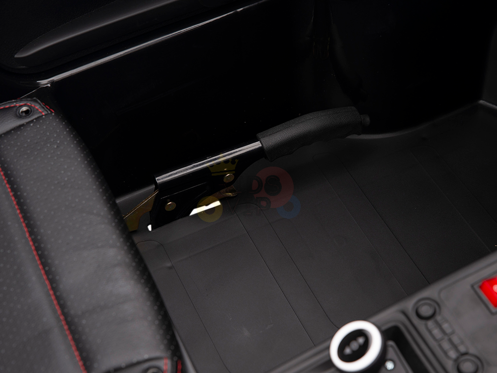 The Red 24V XXL SuperSport Ride On Car features a sleek black leather interior. A stylish handbrake with a black grip and a seat adorned with red stitching adds elegance to the area between the seat and center console.