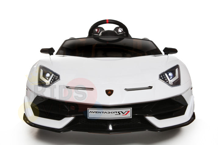 The White 12V Lamborghini SVJ Sport Kids Licensed 1 Seater Ride On Car is shown on a white background. Its front view highlights the sleek design, headlights, and steering wheel, with the Aventador SV logo plate visible—ideal as a remote control car for adventurous kids.