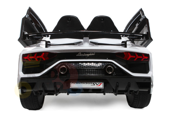 The rear view of the White 12V Lamborghini SVJ Sport Kids Licensed Ride On Car features distinctive taillights, dual exhausts, open scissor doors, and a prominent spoiler. Its aerodynamic design makes it perfect for thrilling adventures.
