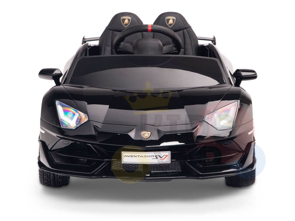 The Black 12V Lamborghini SVJ Sport Kids Licensed Ride On Car features rubber wheels and remote control, mirroring the sleek design of a Lamborghini Aventador with detailed headlights and logo, offering an exhilarating ride.