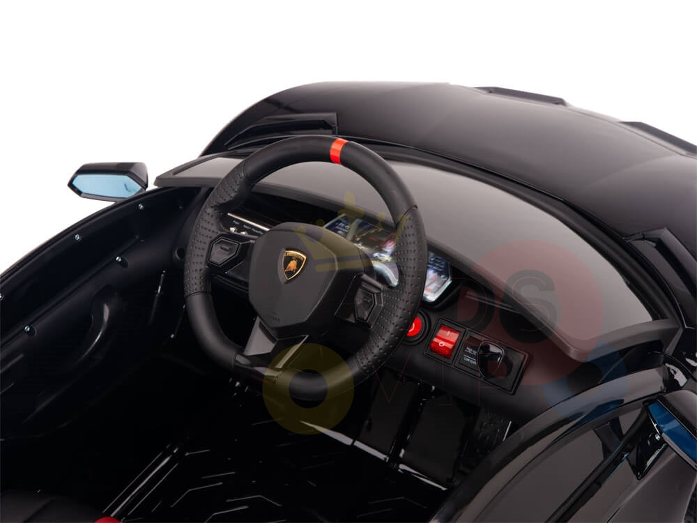 The interior of this luxury ride-on car flaunts a sleek black steering wheel with a red stripe, similar to the Black 12V Lamborghini SVJ Kids Ride On Car. The dashboard includes a digital speedometer and modern controls, while the exterior black side mirror is visible on the left.