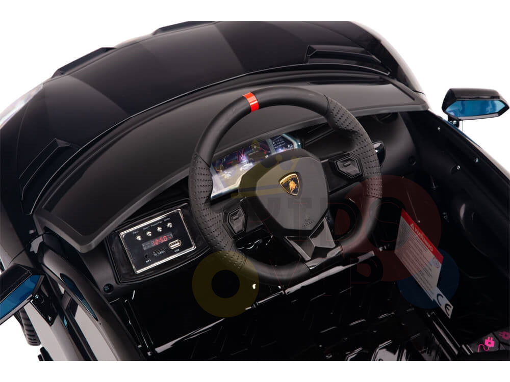 Close-up of the Black 12V Lamborghini SVJ Sport Kids Licensed Ride-On Car dashboard, styled like a luxury sports car with a detailed steering wheel, electronic display, and controls in sleek black and red accents for an electric driving experience.
