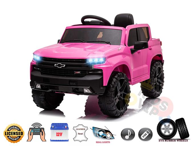 The Pink Official Chevrolet Silverado Truck 12V Kids Ride on Car features large black EVA rubber wheels, blue front lights, leather seats, real lights, music capability, a USB port, and a remote control for safety. It stands out as a licensed model with authentic design elements.