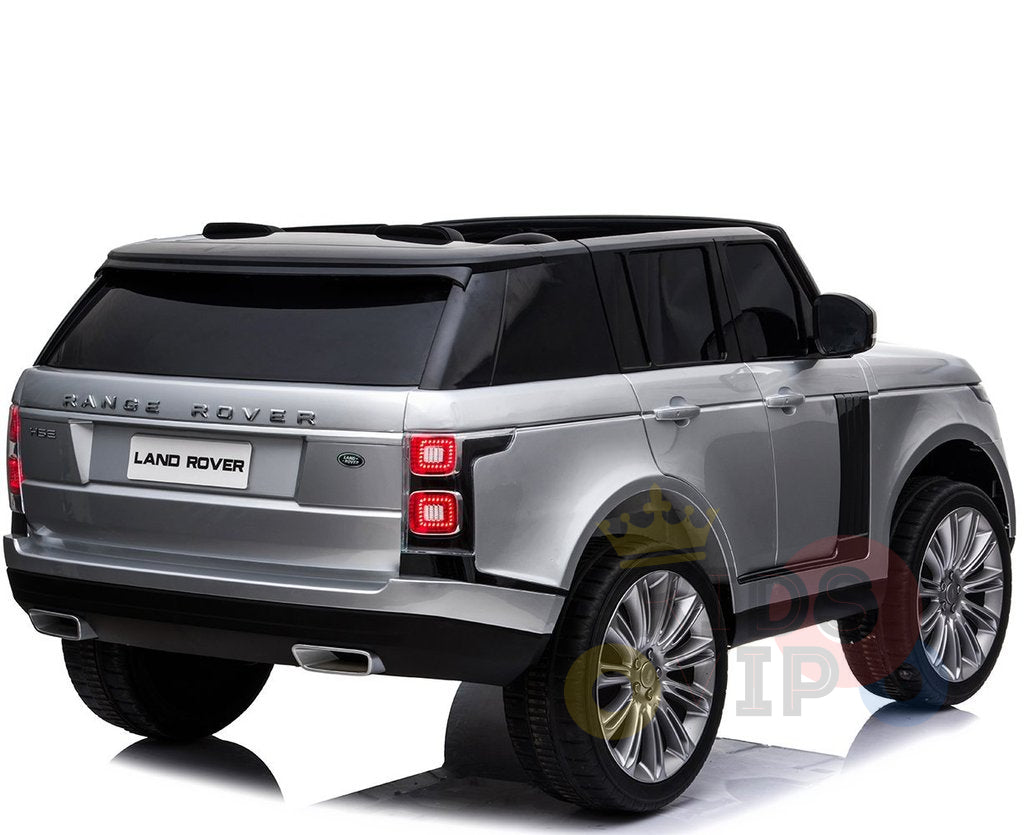 The 24V Complete Silver Edition 2 Seats Range Rover Kids Ride On Car features black-tinted windows, red tail lights, and chrome exhaust pipes. This special edition is captured from the back angle.