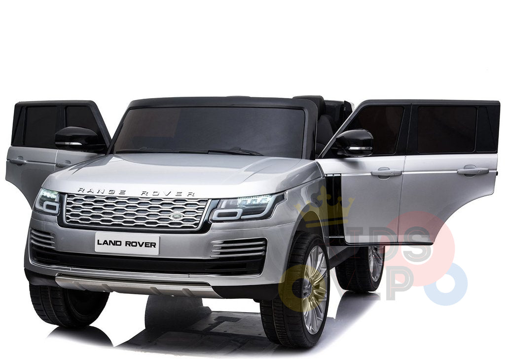 A silver Land Rover Range Rover with open front doors highlights its sleek design, grille, headlights, and prominent wheels—perfectly mimicking the 24V Complete Silver Edition 2 Seats Range Rover Kids Ride On Car with RC, MP4.