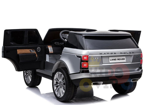 The 24V Complete Silver Edition 2 Seats Range Rover Kids Ride On Car includes one open door revealing its interior, realistic wheels, taillights, and brand logos, all powered by a robust 24V battery for endless adventures.