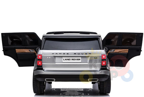 The 24V Complete Silver Edition Range Rover Kids Ride On Car, with rear doors open, showcases a spacious interior. This robustly designed vehicle, featuring two seats and branded Land Rover, stands out against a plain white background.