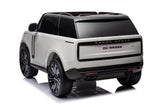 The White 24V Range Rover Ride-On SUV, with EVA wheels and parental control, features a black roof and tinted windows. RANGE ROVER and DK-RR998 are displayed on the back of its sleek design, complemented by sporty black wheels and dual exhausts for a classic touch.